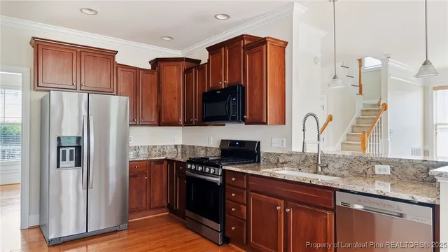 a kitchen with a refrigerator and a sink