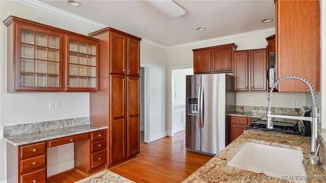 a view of a room with wooden floor and windows