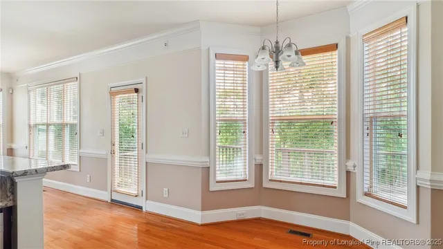 a view of a kitchen with wooden floor and a sink