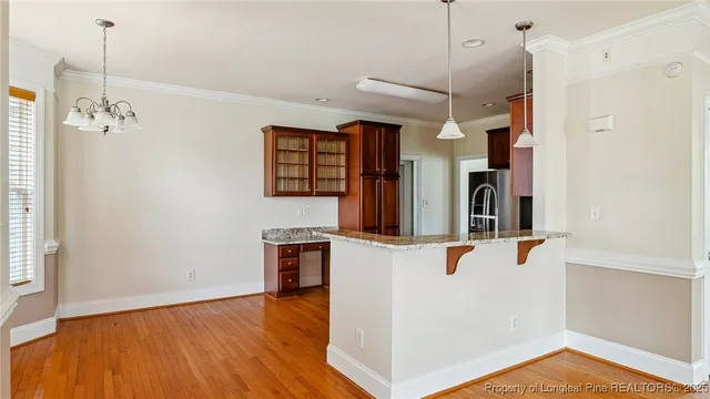 an empty room with a ceiling fan and windows