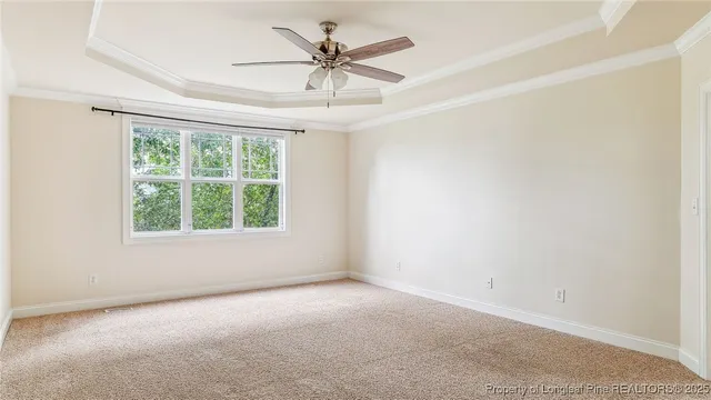 a view of a livingroom with a ceiling fan and window