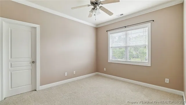 an empty room with a window and a ceiling fan