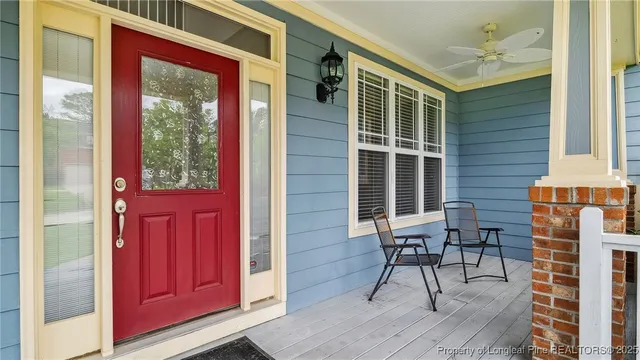 a view of a house with a chairs and table in a patio