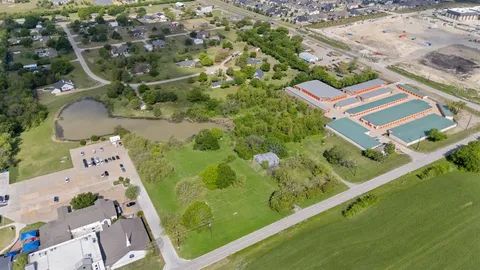 an aerial view of a residential houses with outdoor space