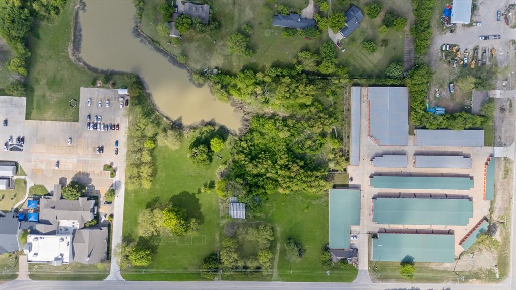 5799 North Custer Road Prosper, TX 75078 - Photo 16 of 21 an aerial view of a house with a yard and large trees