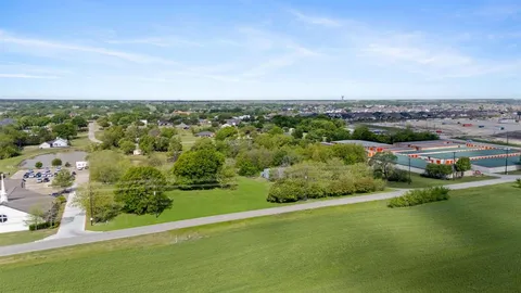 an aerial view of a city with lots of residential buildings ocean and mountain view in back