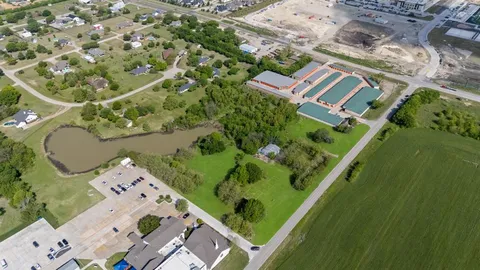 an aerial view of a house a yard and lake view