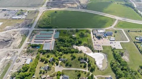 an aerial view of a house with a garden and swimming pool
