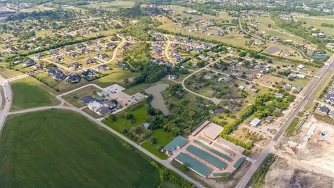 an aerial view of a residential houses with outdoor space