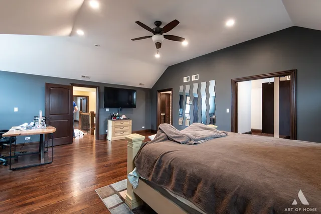 a large bedroom with bed and glass door