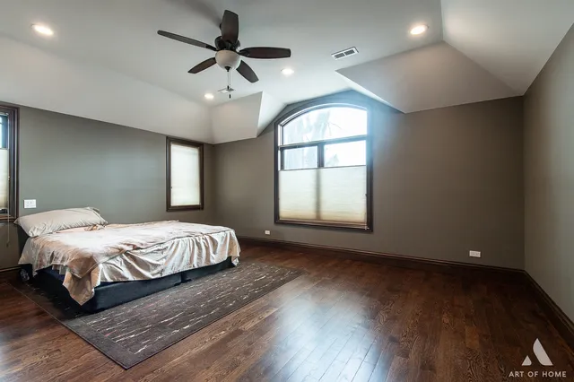 a spacious bedroom with a bed and a window