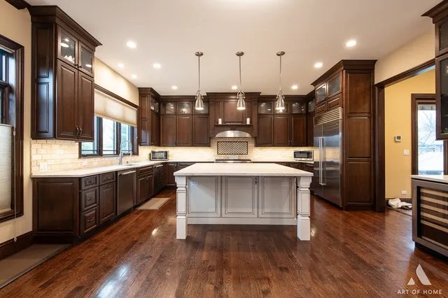 a kitchen with a sink stainless steel appliances and cabinets