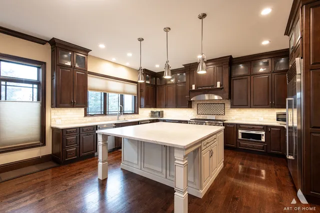 a kitchen with kitchen island a sink stove and wooden floor