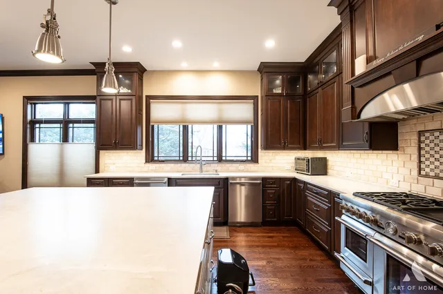 a kitchen with stainless steel appliances granite countertop a sink and stove
