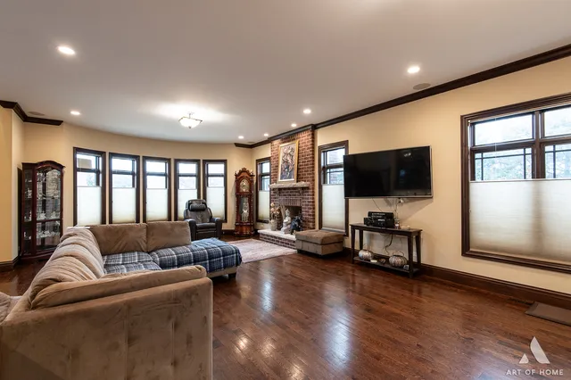 a living room with furniture tv and a flat screen tv