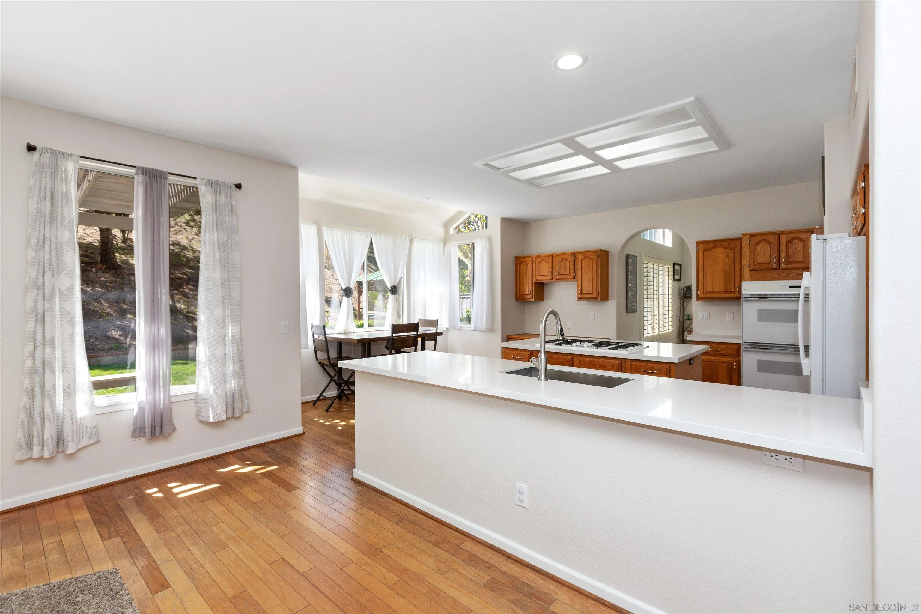 31759 Corte Rosario Temecula, CA 92592 - Photo 13 of 44 a large white kitchen with a large window
