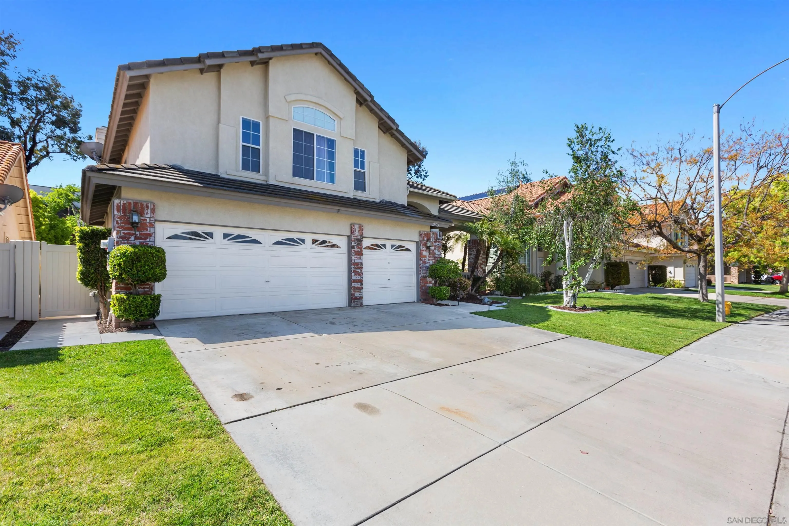 31759 Corte Rosario Temecula, CA 92592 - Photo 2 of 44 a front view of a house with a yard and garage