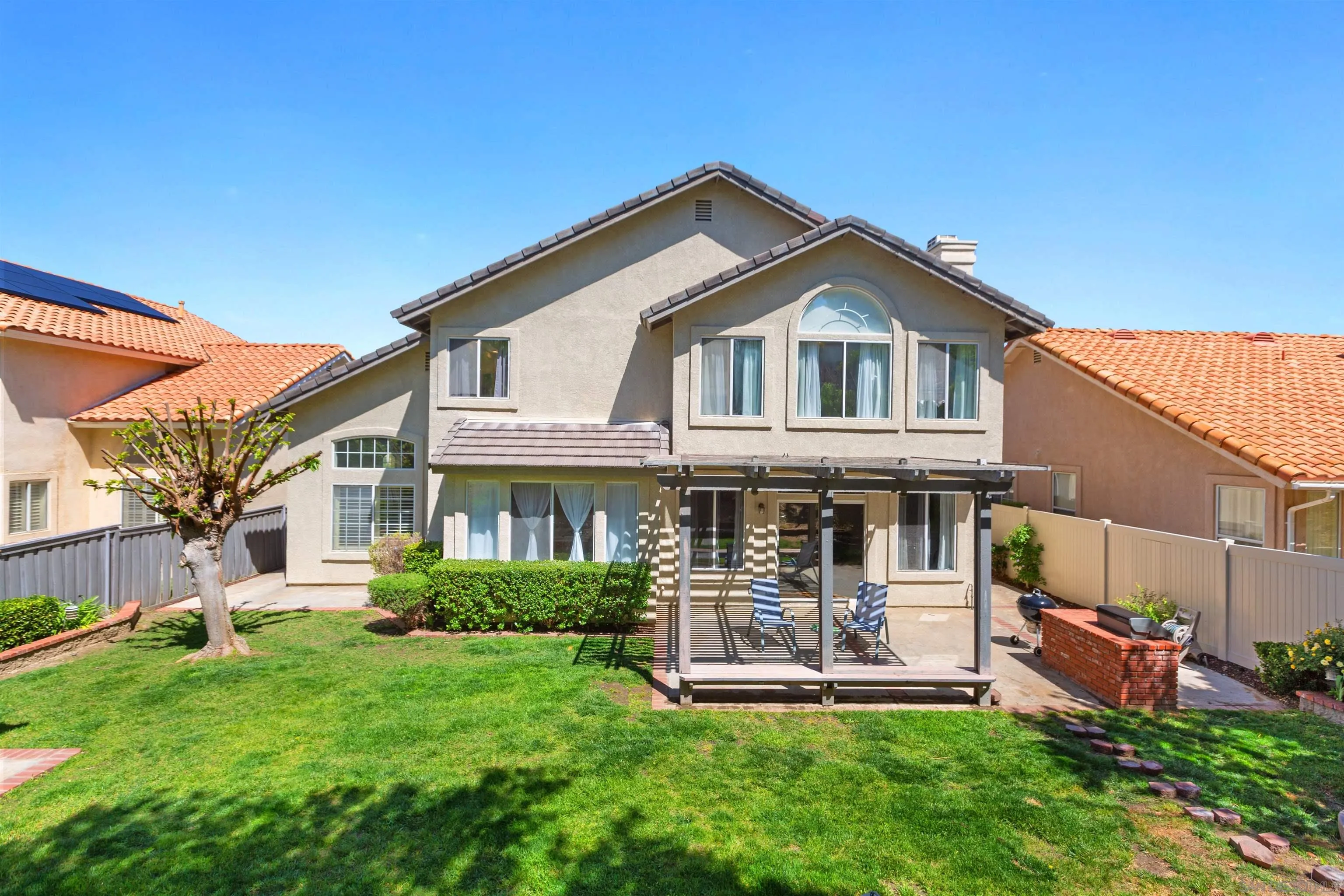 31759 Corte Rosario Temecula, CA 92592 - Photo 33 of 44 a front view of a house with a yard table and chairs