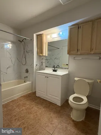 a bathroom with a sink a toilet and bathtub