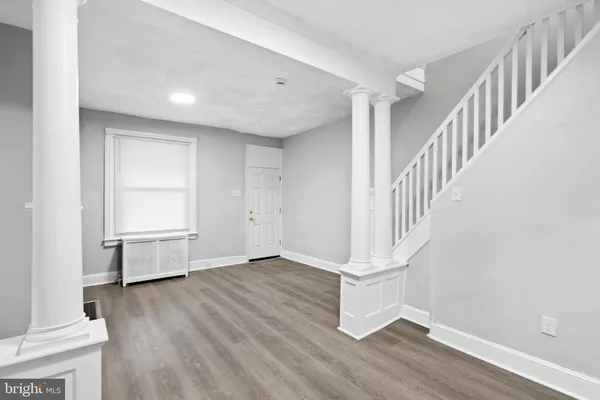 a view of entryway and hall with wooden floor