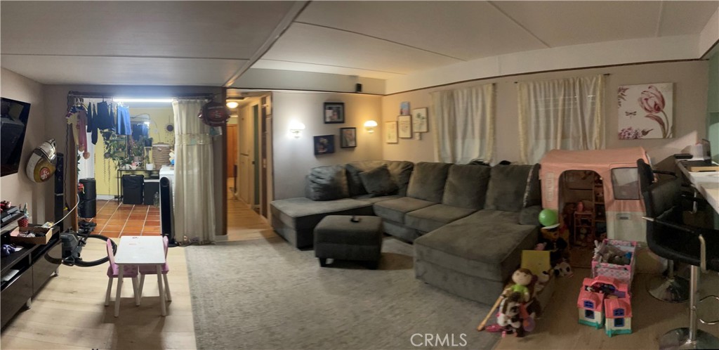 22600 Normandie Avenue, Unit 32 Torrance, CA 90502 - Photo 15 of 40 a living room with furniture a flat screen tv and a view of bedroom