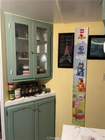 a kitchen with a stove a refrigerator and wooden floor