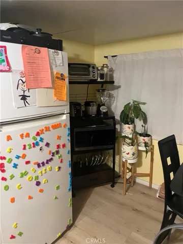 a view of a hallway with couch and dining room