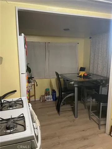 view of a room with rack and wooden floor