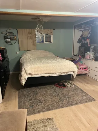 a bedroom with a bed and a large mirror
