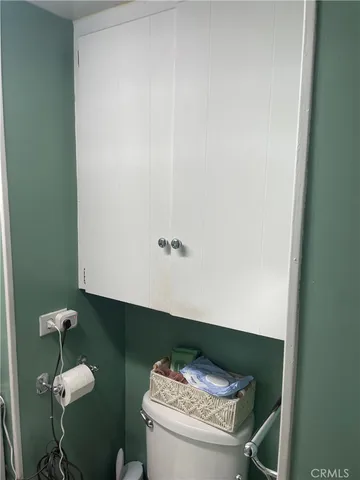 a bedroom with a bed and a large mirror