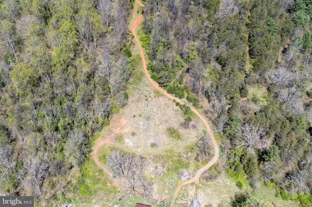a view of a lush green hillside and a building