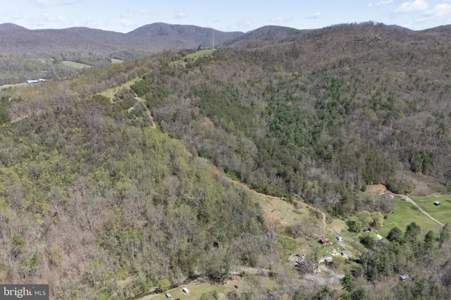 a view of a mountain range with trees in the background
