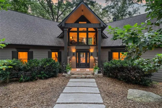 a living room with furniture large window and a fireplace