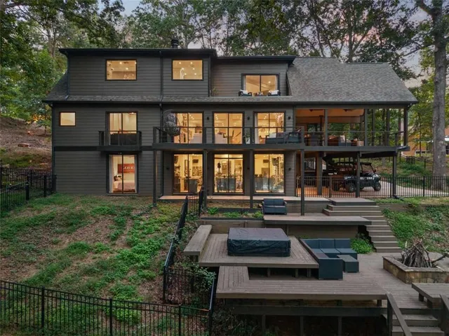 a living room with furniture rug and large windows