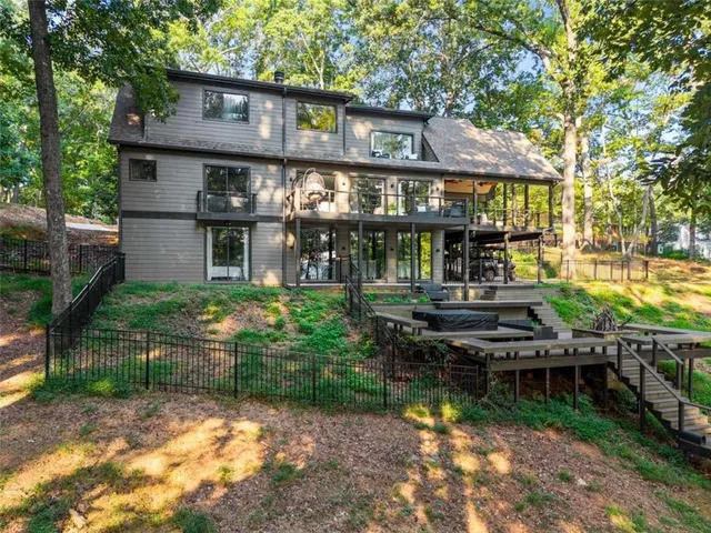 a living room with furniture a fireplace and a large window