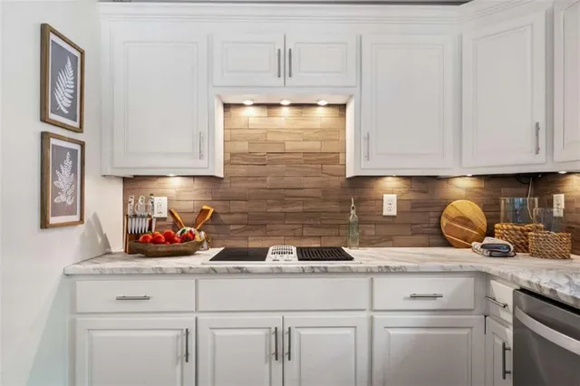 a bathroom with a granite countertop sink a mirror a shower and a sink