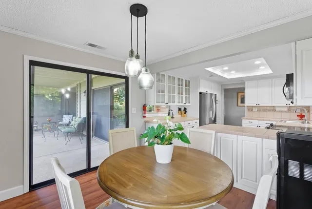 a view of a dining room with furniture wooden floor and chandelier
