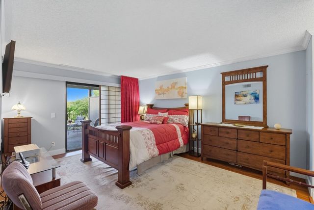 a bed room with a bed window and a dresser