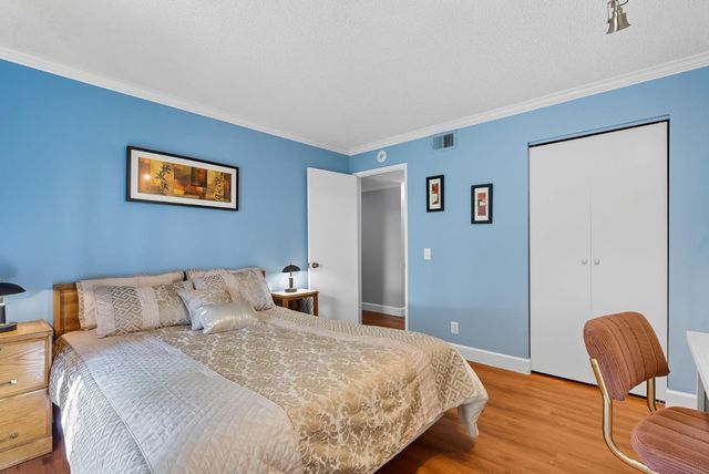 a bedroom with a bed and chair