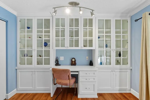 a kitchen with a window and cabinets