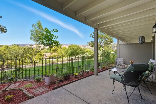 a backyard of a house with outdoor seating