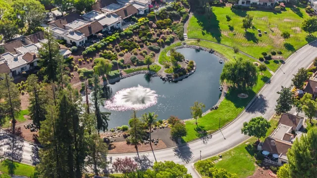an aerial view of a house with a yard and garden