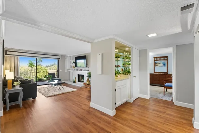 a view of a livingroom with furniture hardwood floor and a window