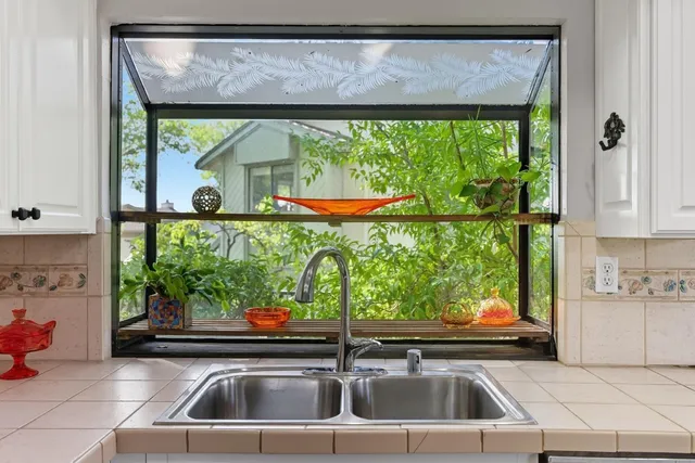 a kitchen with a sink and a large window