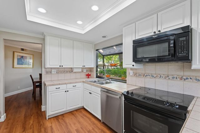 a kitchen with stainless steel appliances a stove sink microwave and cabinets