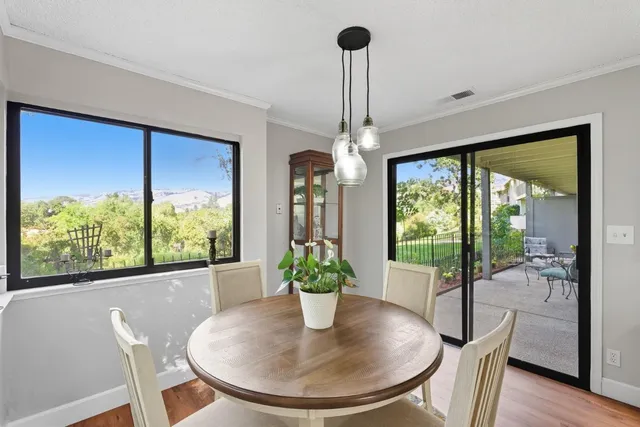 a view of a dining room with furniture window and outside view