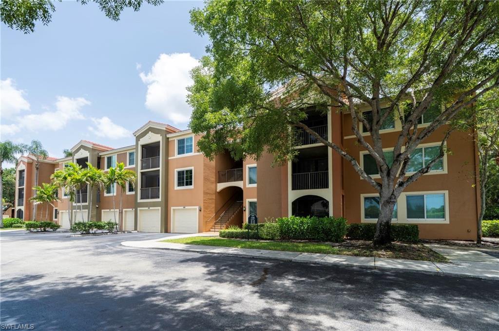 1105 Reserve Court, Unit 206 Naples, FL 34105 - Photo 2 of 23 a front view of a house with a yard