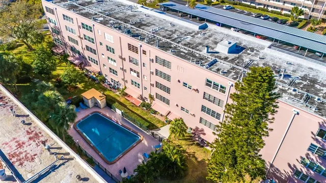 an aerial view of a house with a swimming pool and outdoor space