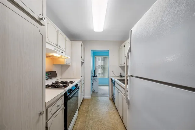 a kitchen with stainless steel appliances a refrigerator a stove and a sink