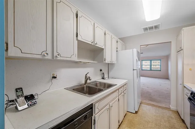 a kitchen with stainless steel appliances granite countertop a sink and cabinets